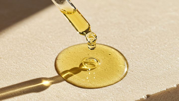 A dropper releasing golden oil