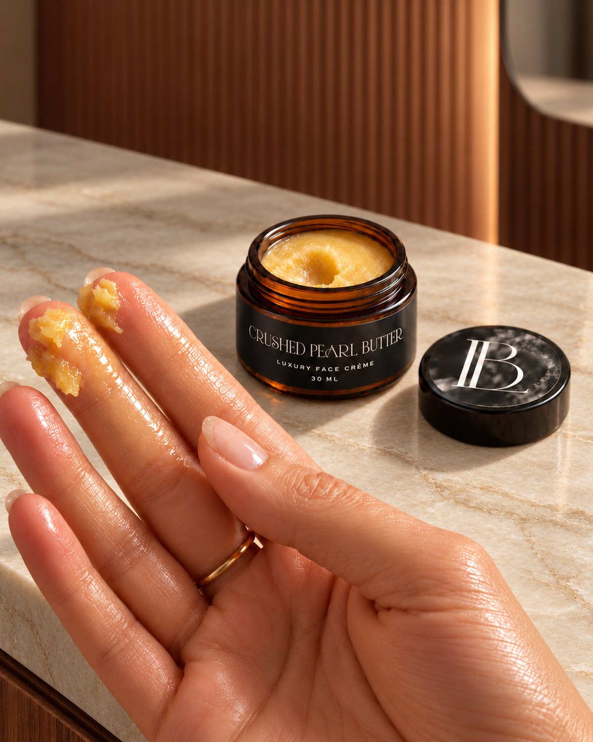 Crushed Pearl Butter on two fingertips beside the open jar